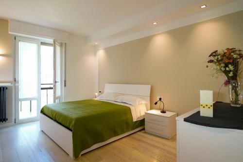 a bedroom with a bed and a vase of flowers at Surville in Aosta