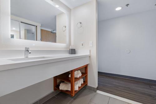 a bathroom with a sink and a mirror at Hotel Avisa Downtown in Morro Bay