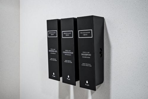 a row of black books hanging on a wall at Hotel Avisa Downtown in Morro Bay