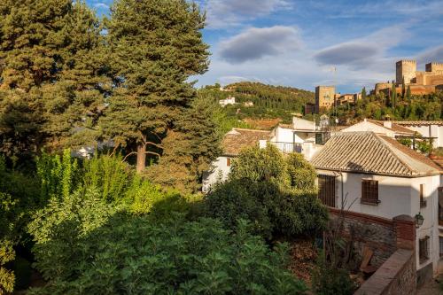 a view of a city with buildings and trees at Albaicin Alhambra Views private terrace in Granada
