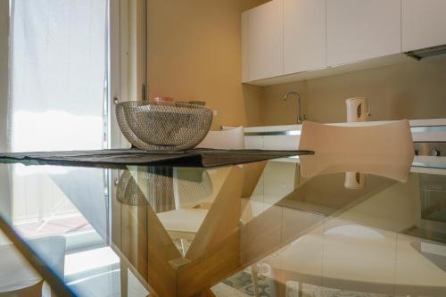 a kitchen with a glass table with a bowl on it at Surville in Aosta
