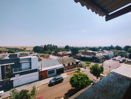 a view of a small town with a car parked in a parking lot at HAPPY HOSPEDAGENS in Cascavel