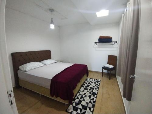 a bedroom with a bed in a room with a door at HAPPY HOSPEDAGENS in Cascavel