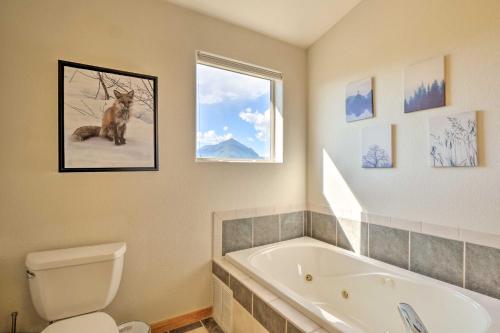 a bathroom with a tub and a toilet and a window at 8 Mi to Keystone Mtn-View Ski Retreat! in Silverthorne