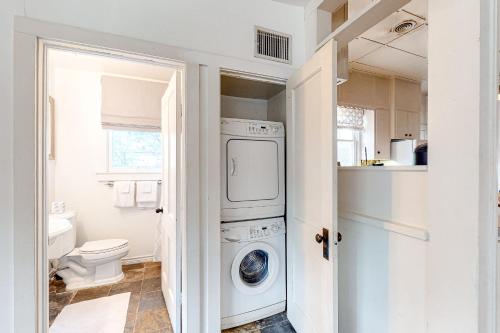 a white laundry room with a washer and dryer at Liberty Creek in Fredericksburg
