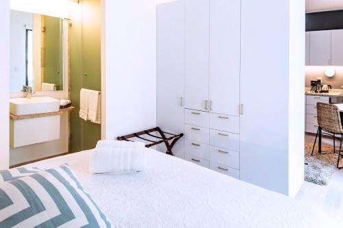 メキシコシティにあるROMÁNTICO Junto a Bellas Artes Centro Históricoの白いベッドルーム(ベッド1台、シンク付)