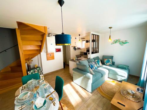 a living room with a couch and a table at Giulia House Fécamp - Seaside Escape, Modern & Cozy in Fécamp