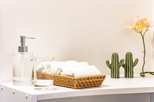 a bathroom shelf with towels and a bottle and a cactus at Muuuy Mexicano A 2 cuadras del Zócalo in Mexico City