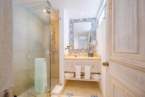 a bathroom with a shower and a sink and a mirror at Mar del Cabo By Velas Resorts in San José del Cabo