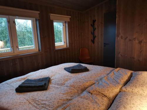 a bedroom with a large bed with two towels on it at Snart er det vår i Hallingdal! in Ål