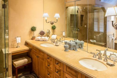 a bathroom with two sinks and a large mirror at Snowmass_Owl_Creek_9904 in Snowmass Village