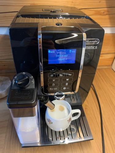 a coffee maker with a cup on a rack at Roubenka Kokořínsko in Dubá