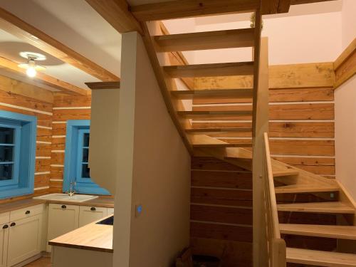 a staircase in the kitchen of a log house at Roubenka Kokořínsko in Dubá