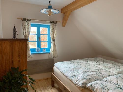 Schlafzimmer mit einem Bett und einem Fenster in der Unterkunft Roubenka Kokořínsko in Dubá