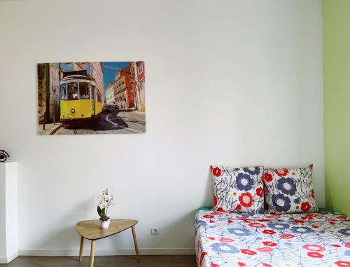 a living room with a couch and a picture of a tram at La Mimi, Grand T2 hyper centre ville in Fontenay-le-Comte