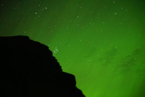 a green sky with the stars in the background at Rauðsdalur in Brjánslækur
