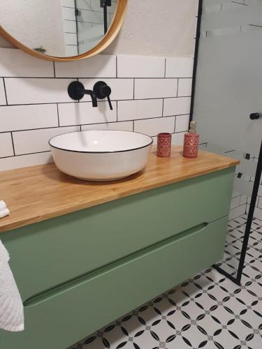 a bathroom with a bowl sink on a counter at נופש ליד הים בת גלים in Haifa