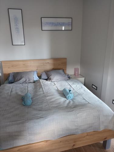 a bedroom with a bed with two blue candles on it at NEW - Frendly Luxury Apartment Franka Zagreb in Zagreb