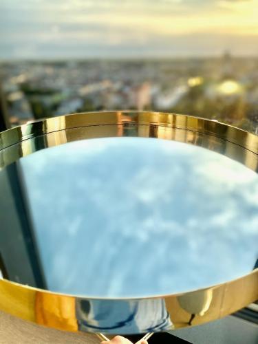 a gold ring with a view of a city at Luksusowy apartament z widokiem, basenem i sauną Hanza Tower Szczecin in Szczecin