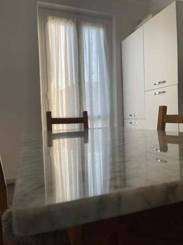 a white kitchen with a dresser and a window at Marchionis in Cremona
