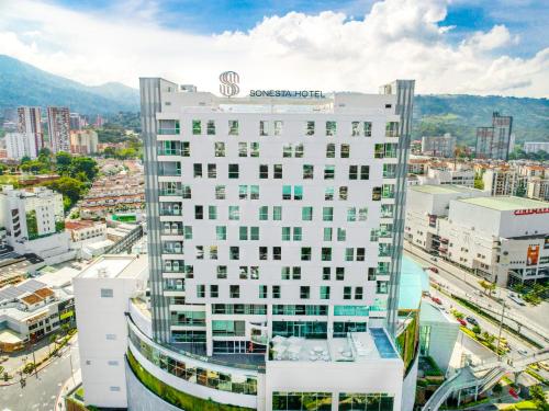 a tall white building with a sign on top of it at Sonesta Hotel Bucaramanga in Bucaramanga