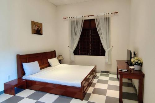 um quarto com uma cama grande e uma janela em Banyan Villa Nha Trang em Nha Trang