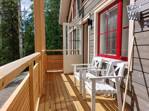una veranda con due sedie e una finestra rossa di Villa Ruskamaja ad Äkäslompolo