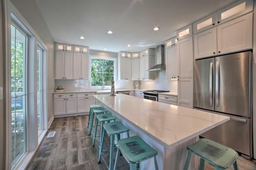 a kitchen with a large island with green stools at Bright and Airy Home Chefs Kitchen and Pro Decor! in Michigan City