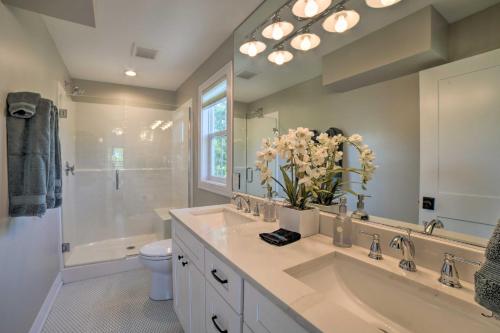 a bathroom with a sink and a toilet and a shower at Bright and Airy Home Chefs Kitchen and Pro Decor! in Michigan City