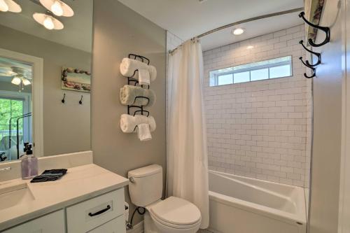 a bathroom with a white toilet and a shower at Bright and Airy Home Chefs Kitchen and Pro Decor! in Michigan City