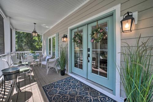 a porch with a blue door and a table and chairs at Bright and Airy Home Chefs Kitchen and Pro Decor! in Michigan City