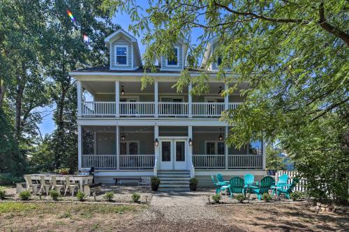 a white house with blue chairs in front of it at Bright and Airy Home Chefs Kitchen and Pro Decor! in Michigan City