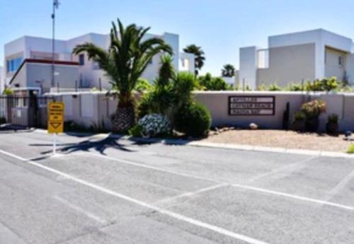 an empty parking lot in front of a building at 30 Nagua Bay in Cape Town
