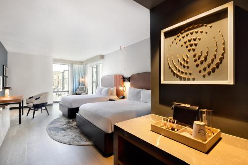 a hotel room with a bedroom with a bed and a desk at Hotel Indigo - Silverthorne by IHG in Silverthorne