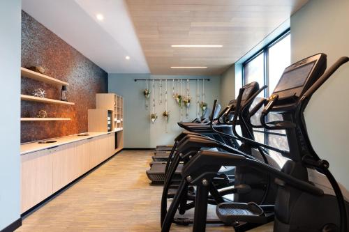 a row of exercise bikes in a fitness room at Hotel Indigo - Silverthorne by IHG in Silverthorne