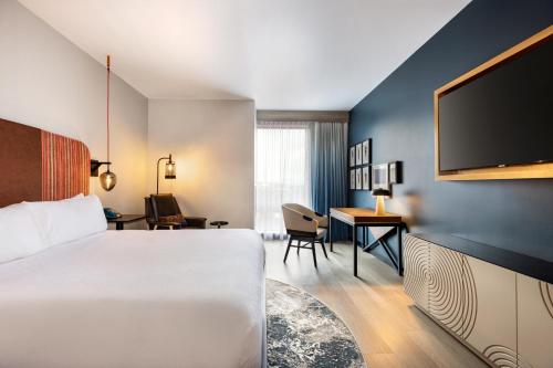 a hotel room with a bed and a desk at Indigo - Silverthorne, an IHG Hotel in Silverthorne
