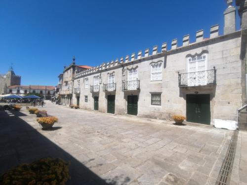 an empty street with a large stone building at Casa Pita Caminha in Caminha