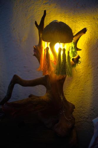 a lamp with a group of birds on it at El árbol de la vida Hostel - Private Rooms Near Bacalar Lagoon in Bacalar
