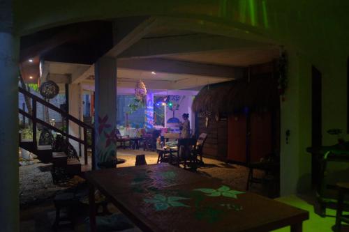 a dining room with a table in a room with lights at Near Lake Hostal in Bacalar