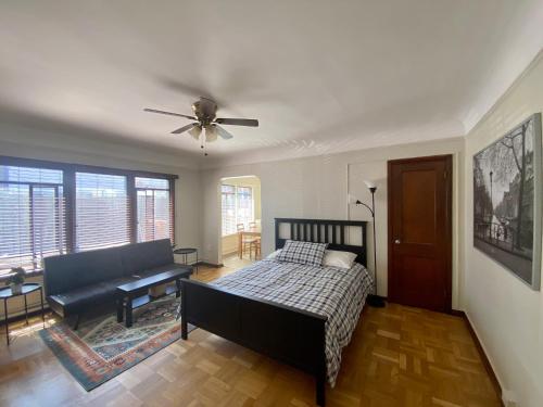 a bedroom with a bed and a ceiling fan at Furnished Apartments - Climate Pledge Arena Next Door in Seattle