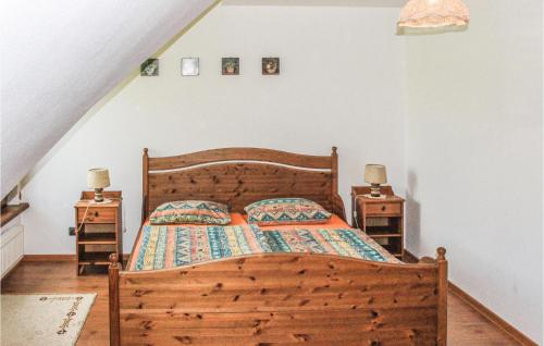 a bedroom with a wooden bed and two night stands at Stunning Home In Jedwabno With 3 Bedrooms in Jedwabno