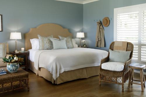 a bedroom with a large bed with blue walls at Verandah House Country Estate in Mount Tamborine