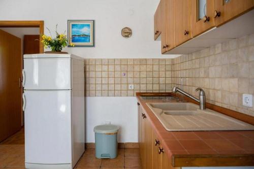 a kitchen with a white refrigerator and a sink at Apartments with a parking space Bol, Brac - 20004 in Bol