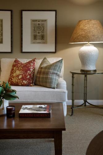 a living room with a couch and a table with a lamp at Verandah House Country Estate in Mount Tamborine