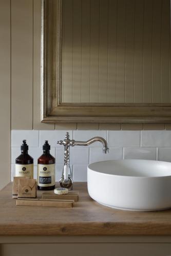 a bathroom counter with a sink and a mirror at Verandah House Country Estate in Mount Tamborine