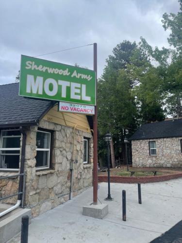 a motel sign in front of a building at Sherwood Arms Motel in Running Springs