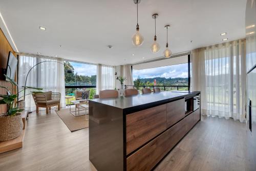 a kitchen with a large island in a living room at Olive Living Suites by HOUSY HOST in Envigado