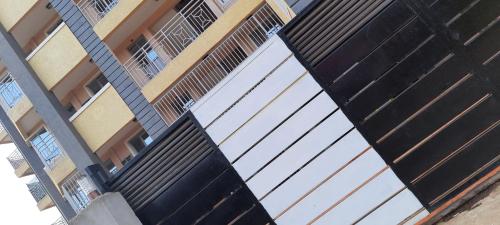 a building with two white garage doors on it at Cosy 1-bedroom Hideout outside the city limits in Ruiru