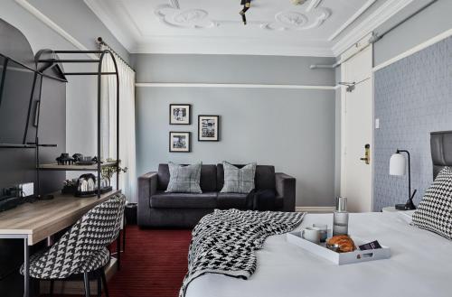 a bedroom with a bed and a living room at No 9 Springfield in Sydney