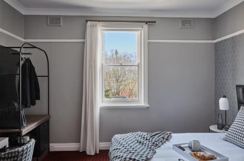 um quarto com uma cama e uma janela em No 9 Springfield em Sydney